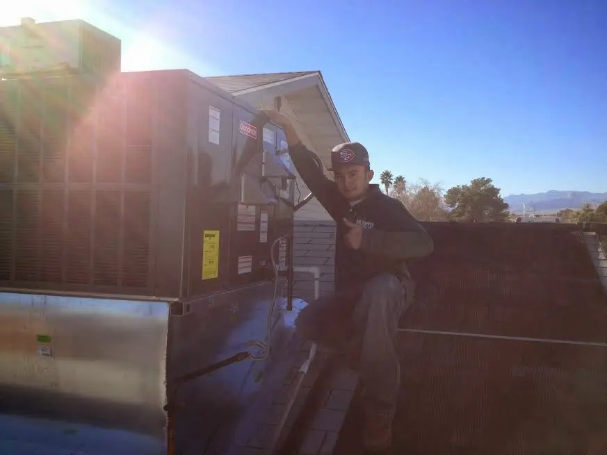 HVAC technician performing AC Tune-Up on a rooftop unit in Wickliffe